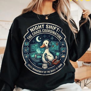 May include: A white ceramic mug with a black handle and the text "But First, Coffee" in a black, handwritten-style font. The mug is on a white surface.