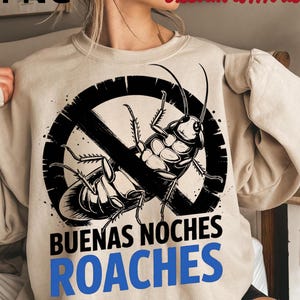 May include: Beige sweatshirt with a black and white graphic of a cockroach inside a no-entry symbol. The text "BUENAS NOCHES ROACHES" is printed below the graphic in black and blue.