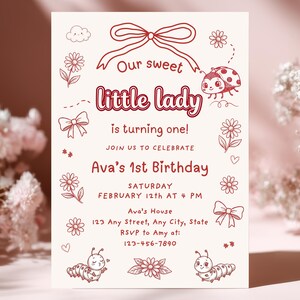May include: A light beige birthday invitation with red illustrations and text. The text reads "Our sweet little lady is turning one!" and includes details for Ava's 1st birthday, such as the date, time, and location. Decorative elements include flowers, bows, and a ladybug.