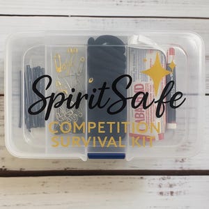 May include: A clear plastic container labeled "Spirit Safe Competition Survival Kit." The kit includes bobby pins, safety pins, hair ties, and other small items. The text is in black and gold.