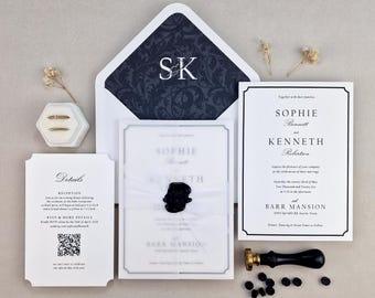 May include: Elegant wedding invitation suite featuring a navy blue and white floral patterned envelope with initials. Includes invitation cards, RSVP details, and a wax seal. The suite is arranged on a neutral background.