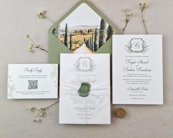 May include: Elegant wedding invitation suite featuring a landscape-printed envelope, invitation cards, and a reply card. The main invitation is tied with a white ribbon and sealed with a green wax seal. The suite is arranged on a neutral surface.