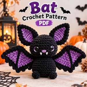 May include: A crochet bat plushie with a black body and purple inner wings and ears. The bat has large black eyes with purple irises, a small pink nose, and two white fangs. The text above reads Bat Crochet Pattern PDF.