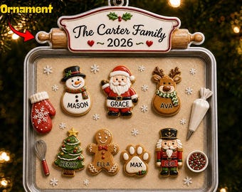May include: A rectangular Christmas ornament shaped like a baking sheet with a rolling pin top. It features the text The Carter Family 2026 and various cookie-shaped figures labeled Mason, Grace, Ava, Henry, Ella, Max, and Leo, plus baking tools.