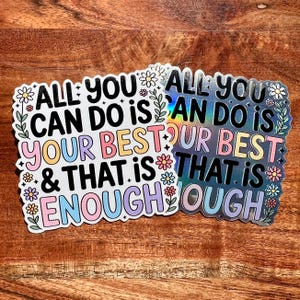 Puede incluir: Dos pegatinas con el texto "ALL YOU CAN DO IS YOUR BEST & THAT IS ENOUGH". Una es blanca con texto colorido y detalles florales, la otra es hologr&aacute;fica con texto similar.