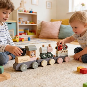 May include: Wooden toy train with pastel colors. The train has multiple cars with different designs, including a ladybug, a rainbow, and the name "Helena". The train is on a beige carpet.