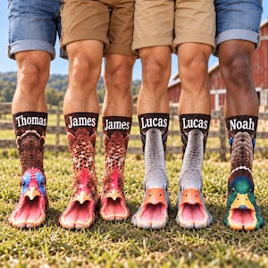 May include: Six crew socks featuring realistic animal face prints including turkeys, geese, and a mallard duck. Each sock displays a name at the top: Thomas, James, James, Lucas, Lucas, and Noah. The designs feature open-beak patterns at the toes.