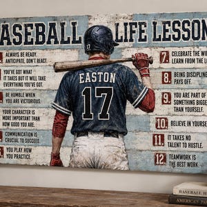 May include: A rectangular wall sign titled BASEBALL LIFE LESSONS featuring a baseball player in a dark blue jersey with the name EASTON and number 17, holding a bat. The sign lists twelve numbered life lessons on a weathered blue and white wood background.