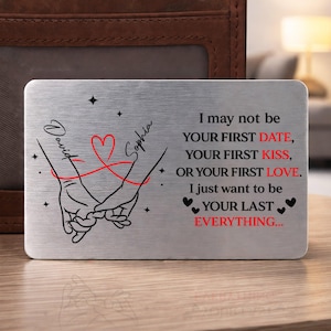 May include: A silver metal wallet card with the names "David" and "Sophia" in script. The card features a red heart and intertwined hands graphic. Text on the card reads "I may not be your first date... I just want to be your last everything."