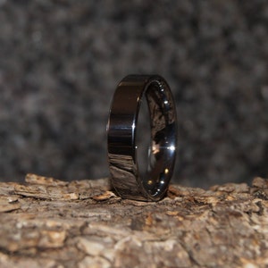 May include: A silver wedding band with a polished finish.