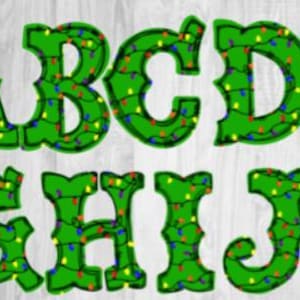 May include: Green Christmas alphabet letters A to K, each adorned with colourful string lights. The letters are set against a light wood grain background, creating a festive holiday design.