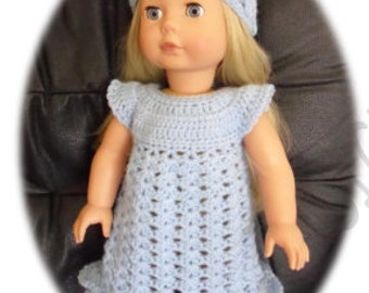 May include: A light blue crocheted dress with a ruffled hem and matching headband for a doll.