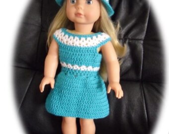 May include: A doll wearing a teal crochet dress with white trim and a white crochet hat. The doll has blonde hair and blue eyes.
