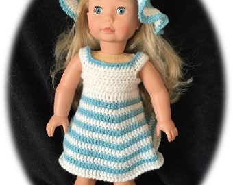 May include: A doll wearing a blue and white striped crochet dress and a blue crochet sun hat.