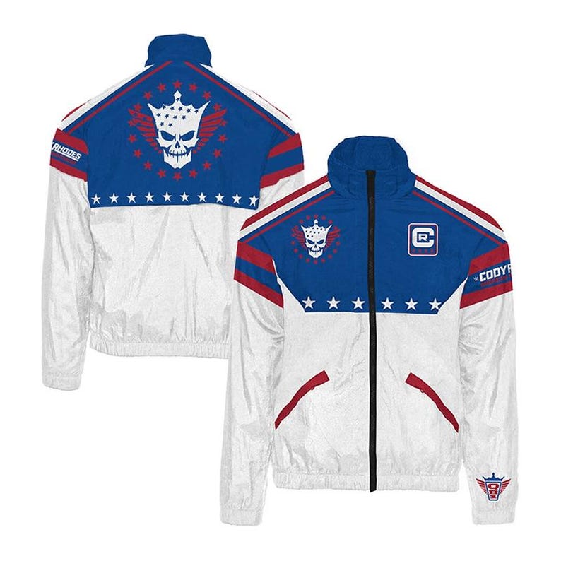 May include: White and blue zip-up jacket with red accents. The jacket features a skull and crown design on the back and chest, along with the name "RHODES" on the shoulder. The jacket has a high collar and a front zipper.