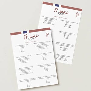 May include: Two white paper quiz sheets with the text "17 mai QUIZ" in a handwritten style, with a red and blue stripe at the top. The quiz sheets have questions and answers in Norwegian.
