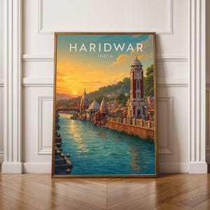 May include: A framed wall art print depicting a sunset view of Haridwar, India, featuring a river flowing past stone ghats, traditional temple architecture, and a prominent clock tower. The text HARIDWAR INDIA is printed in white at the top.
