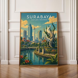 May include: A framed travel poster titled SURABAYA EAST JAVA, INDONESIA, featuring a city skyline with skyscrapers, a monument, and a canal. In the foreground, a large sculpture of a shark and a crocodile emerges from green foliage.