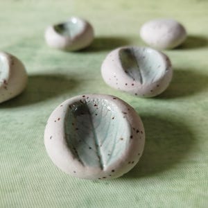 Green textured worry stone with sage imprint, round thick grounding stone, thumb stone of speckled clay