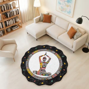 May include: Round yoga mat with a black scalloped edge. The center features a white circle with a colorful geometric design of a person in a yoga pose. The mat is surrounded by a black border with colorful accents. This yoga mat is perfect for home use.