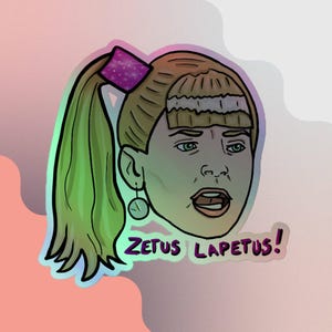 May include: Holographic sticker featuring a cartoon illustration of a woman's face with a surprised expression. She has blonde hair in a ponytail with a purple bow. The sticker has the text "Zetus Lapetus!" in purple.