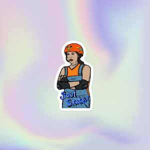 May include: A sticker featuring a cartoon illustration of a person in an orange helmet, orange top, and blue overalls, with the text "Soul Skate" in blue script. The person has their arms crossed and is wearing elbow pads.