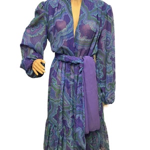 May include: A long-sleeved, purple and green patterned dress with a deep V-neckline and a matching purple sash.