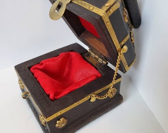 Wood and brass grommet box with red lining