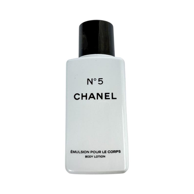 May include: A white rectangular bottle of Chanel N&deg;5 body lotion with a black cap. The product name and brand are printed in black. The bottom of the bottle reads "&Eacute;MULSION POUR LE CORPS BODY LOTION."
