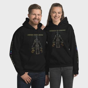 May include: Black hooded sweatshirts with a graphic design featuring a human figure and the text "LIGHTCODE ACTIVATION EMBODIMENT". The sweatshirts have additional text on the sleeves and are worn by two people.