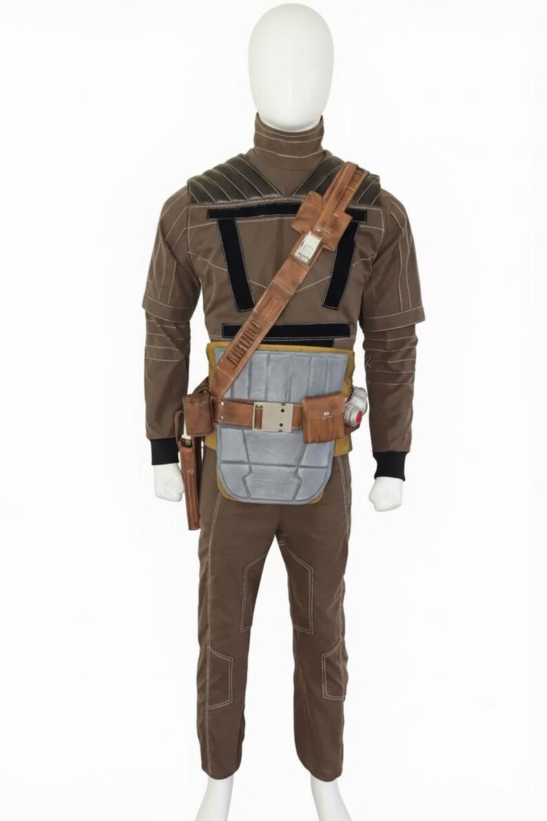 May include: A brown costume displayed on a mannequin. The outfit includes a long-sleeved top, pants, and a utility belt with pouches and a holster. The costume has black accents and a shoulder strap. The mannequin is on a white background.