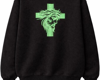 May include: Black sweatshirt featuring a neon green graphic of a cross with a depiction of Jesus wearing a crown of thorns. The design is centered on the front of the long-sleeved crew neck top. The sweatshirt is made of a soft material.