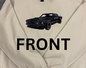 May include: Cream-colored sweatshirt with a black embroidered classic car design. The word "FRONT" is printed in large black letters at the bottom of the sweatshirt. The sweatshirt has long sleeves and a crew neck.
