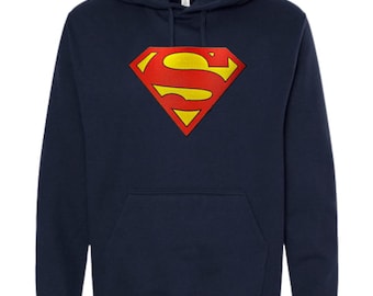 May include: A navy blue long-sleeve hooded sweatshirt featuring a large, centered Superman logo. The emblem is a yellow 'S' inside a red diamond shape with a yellow border. The hoodie includes a front kangaroo pocket and matching drawstring cords.