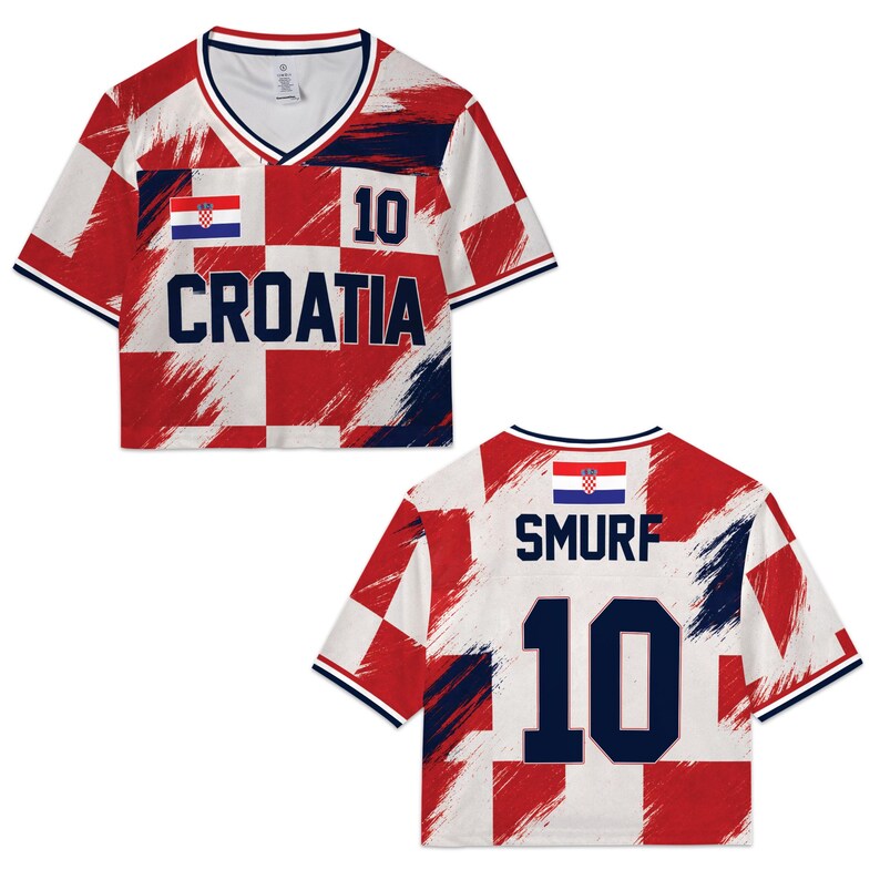 May include: A white, red, and navy blue Croatia soccer jersey with the number 10. The front of the shirt says "CROATIA" and the back says "SMURF". The jersey has a V-neck and a Croatian flag on the front and back.