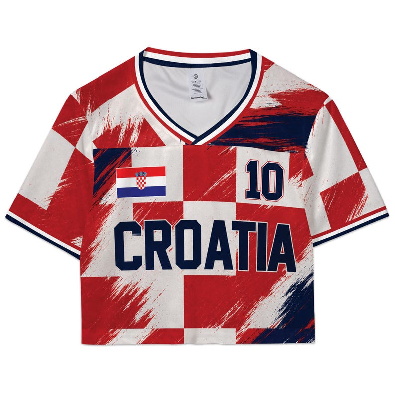 May include: Croatia crop top in red and white checkered pattern with the word "CROATIA" in navy blue. Features the Croatian flag and the number "10". The top has a V-neck and navy blue trim.