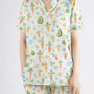 May include: A white ceramic mug with a black handle and the text "But First, Coffee" in a black, bold font. The mug is on a white surface.