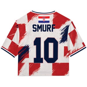 May include: A white and red Croatian-themed jersey with the word "SMURF" and the number "10" in navy blue. The jersey features the Croatian flag and a brushstroke design. The sleeves have navy blue trim.