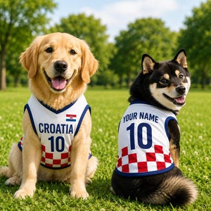 May include: Two dogs wearing white sleeveless jerseys with blue trim and a red and white checkered pattern at the bottom. One jersey features the text CROATIA, the number 10, and a small Croatian flag. The other jersey displays YOUR NAME and the number 10.