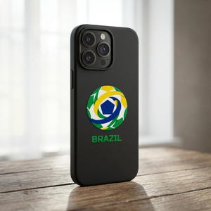 May include: Black phone case with a Brazil soccer ball design. The case features a circular emblem with green, yellow, blue, and white colors, and the word "BRAZIL" in green text below the emblem.