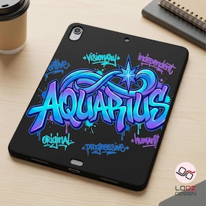May include: Black tablet case featuring a graffiti-style design with the word "AQUARIUS" in blue and purple. The case includes additional words like "visionary" and "original". A star and paint splatters complete the design.
