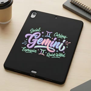 May include: Black tablet case with a colorful Gemini design. The design includes the word "Gemini" in a cursive font, along with the words "Social", "Curious", "Expressive", and "Quick-Witted". The case has a camera and other ports.