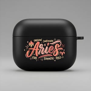 May include: Black AirPods case with the word "Aries" in a stylized, coral-colored script. The design includes the words "Passion, Confidence, Fire, Strength, Bold" in white and coral accents, with star and flame illustrations.