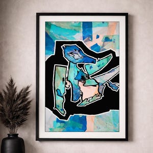 May include: A framed abstract wall art print featuring a central black shape with a thick white outline. The interior of the shape contains layered textures in shades of turquoise, light blue, and soft peach, set against a light blue background.