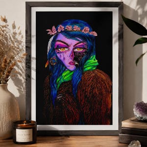 May include: A framed art print featuring a stylized portrait of a person with blue hair, a pink flower crown, and golden eyes. The figure wears a brown textured coat and a bright green scarf, set against a solid black background with vibrant colors.