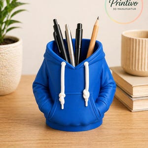 May include: A royal blue desk organizer shaped like a hoodie, with white drawstrings and a front pocket. The organizer holds pens and a pencil. The Printivo logo is visible in the background.