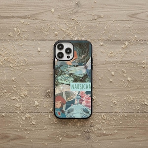 May include: Black phone case featuring a collage of images with a fantasy theme. The design includes illustrations of a girl, mushrooms, and a dragonfly. The word "NAUSICAA" is printed in a light blue font on the case.