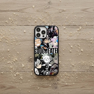 May include: Black phone case featuring a collage of anime characters and the text "SOUL EATER" in white. The case has a glossy finish and a black border, with a multi-lens camera cutout.