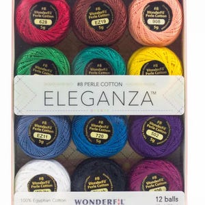 May include: A set of 12 balls of WonderFil Eleganza #8 Perle Cotton thread in various colors, including red, green, yellow, blue, purple, white, and black. Each ball is 5g and 42yd. The packaging features the text #8 PERLE COTTON ELEGANZA.