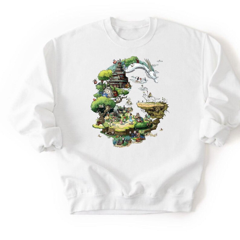May include: White crewneck sweatshirt featuring a colorful illustration of a fantasy landscape with a pagoda, a dragon, and various characters. The design is set against a backdrop of green trees and floating islands.
